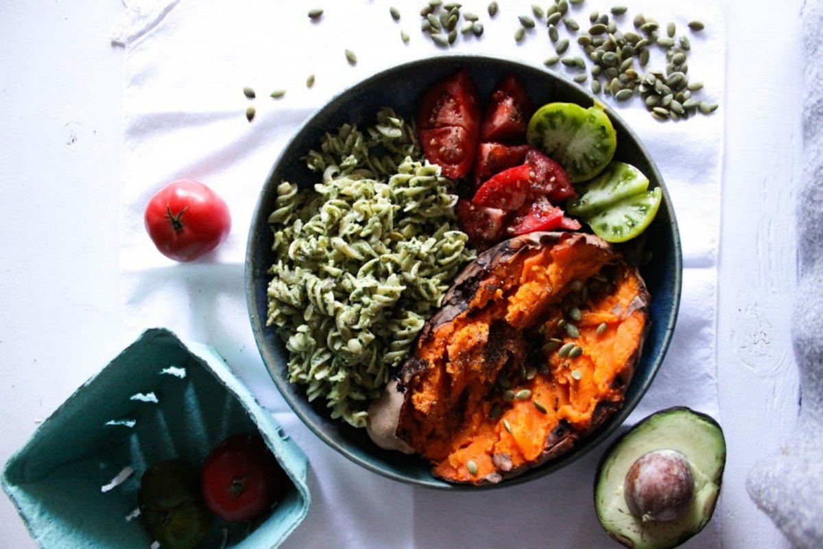 The-Glow-Bowl-Baked-Sweet-Potato-With-Pesto-Pasta-Tomatoes-and-Pumpkin-Seeds-1200x800