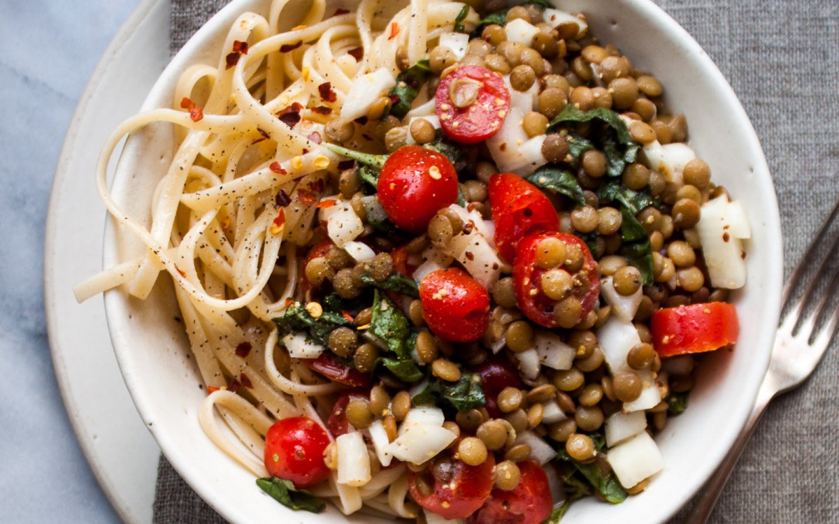 Tomatoes and lentils over pasta