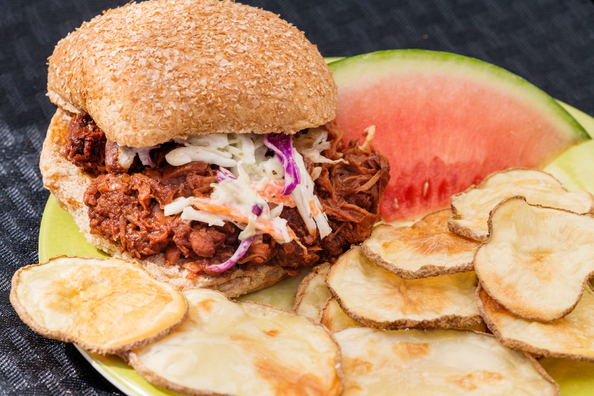BBQ Jackfruit in a burger with chips and watermelon