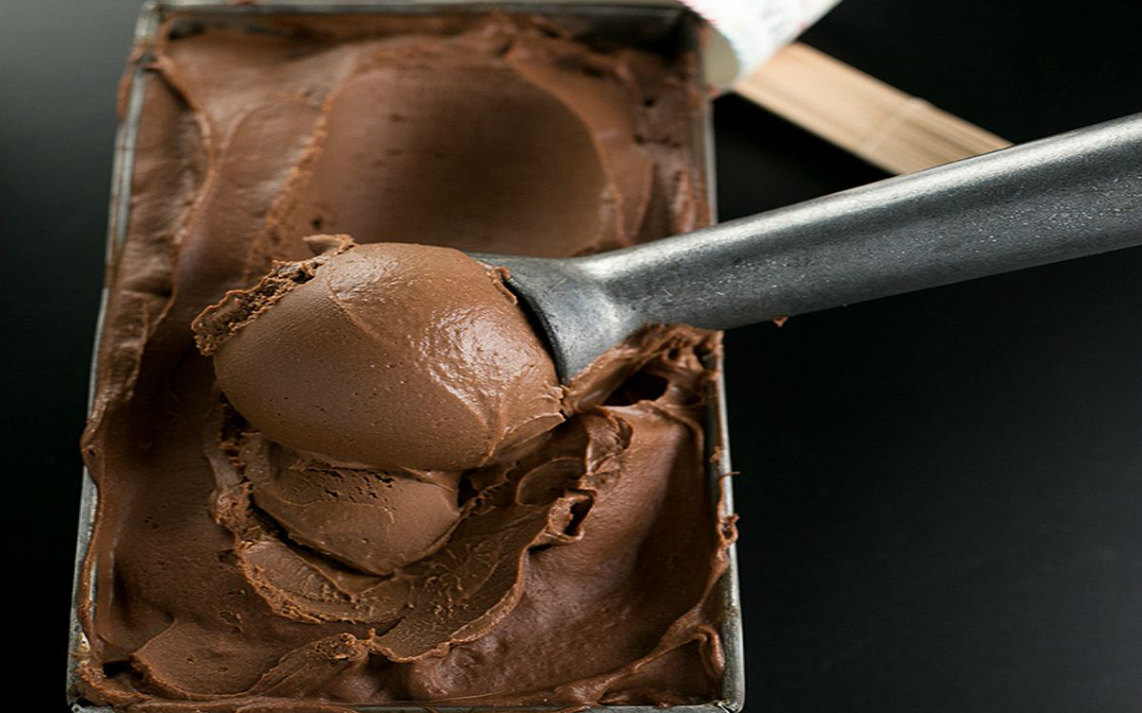 Scooping creamy chocolate ice cream