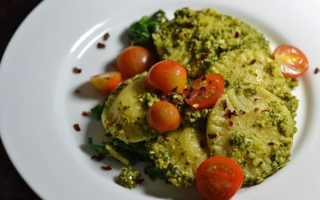 Vegan Ravioli With Kale Pesto And Sautéed Chard and fresh tomatoes