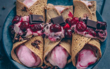 Vegan Gluten-Free Peanut Cinnamon Crepes With Cherry Quark topped with cherries and chocolate
