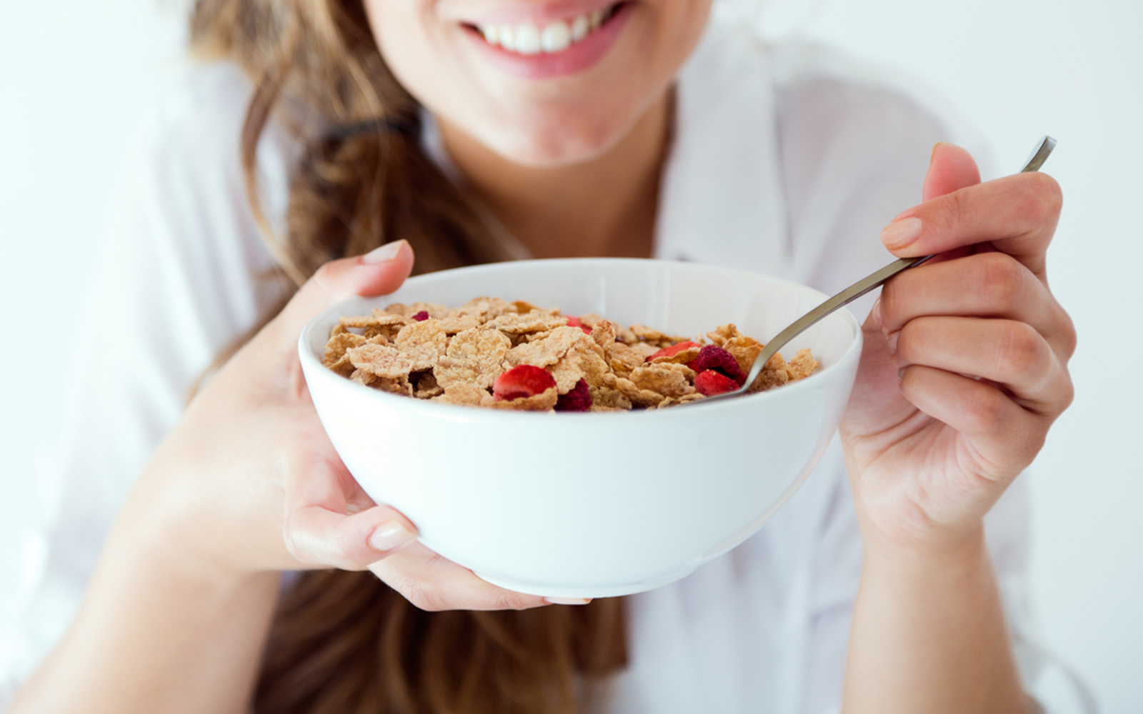 Happy woman with vegan breakfast cereal