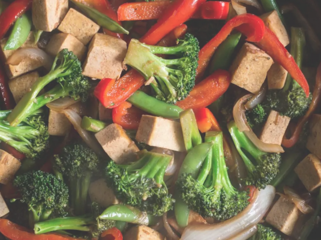 Fry vegan tofu broccoli while stirring