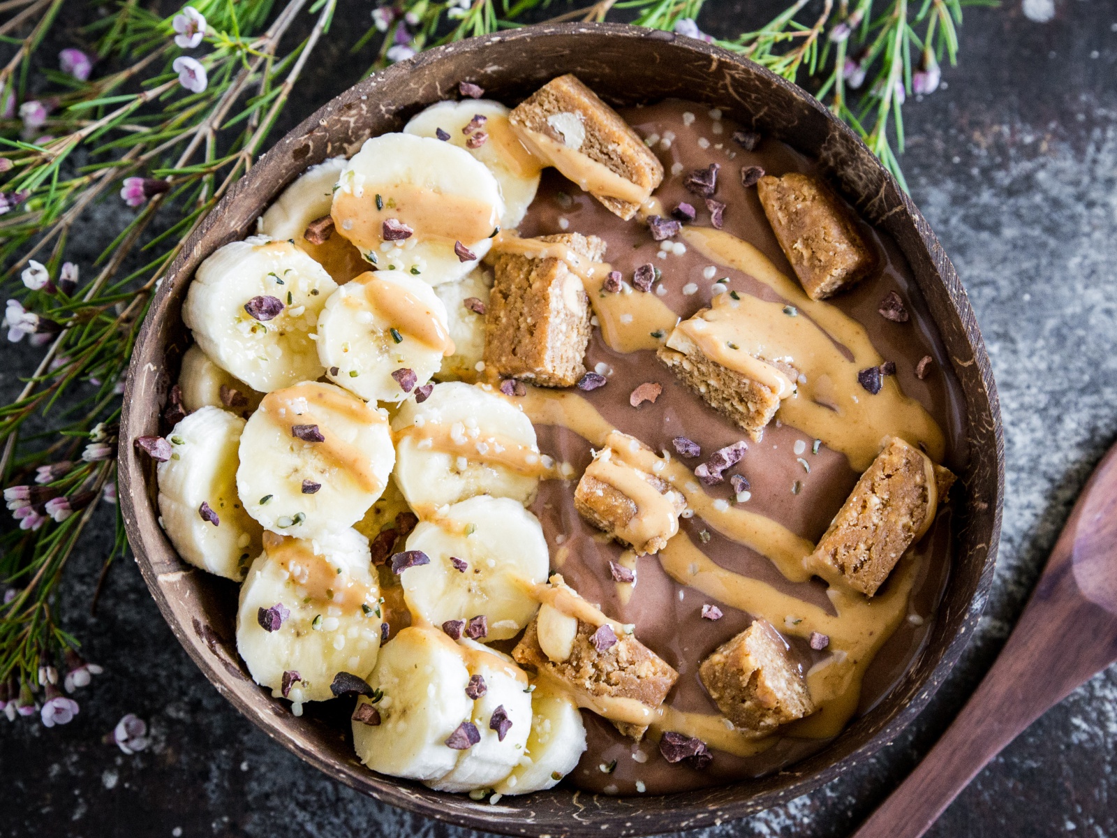 Vegan Yogurt Power Bowl topped with bananas and a nut butter drizzle