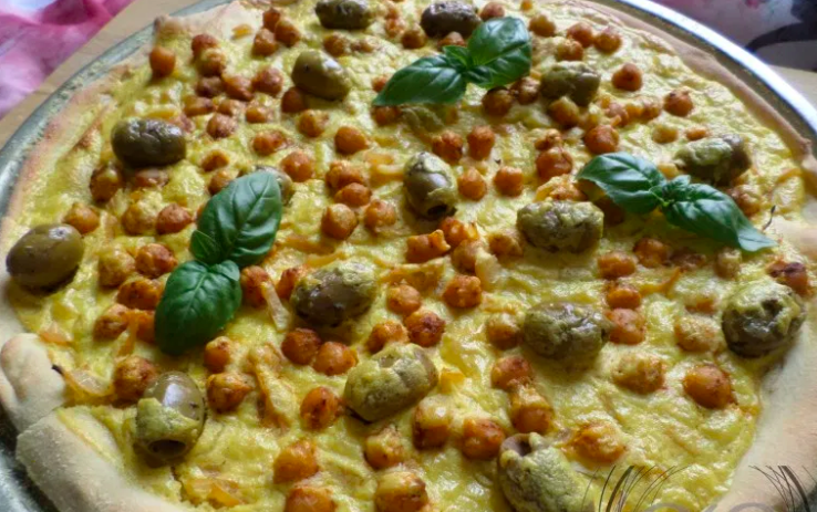 Moroccan style pizza with seasoned chickpeas, preserved lemon, olives and saffron crema