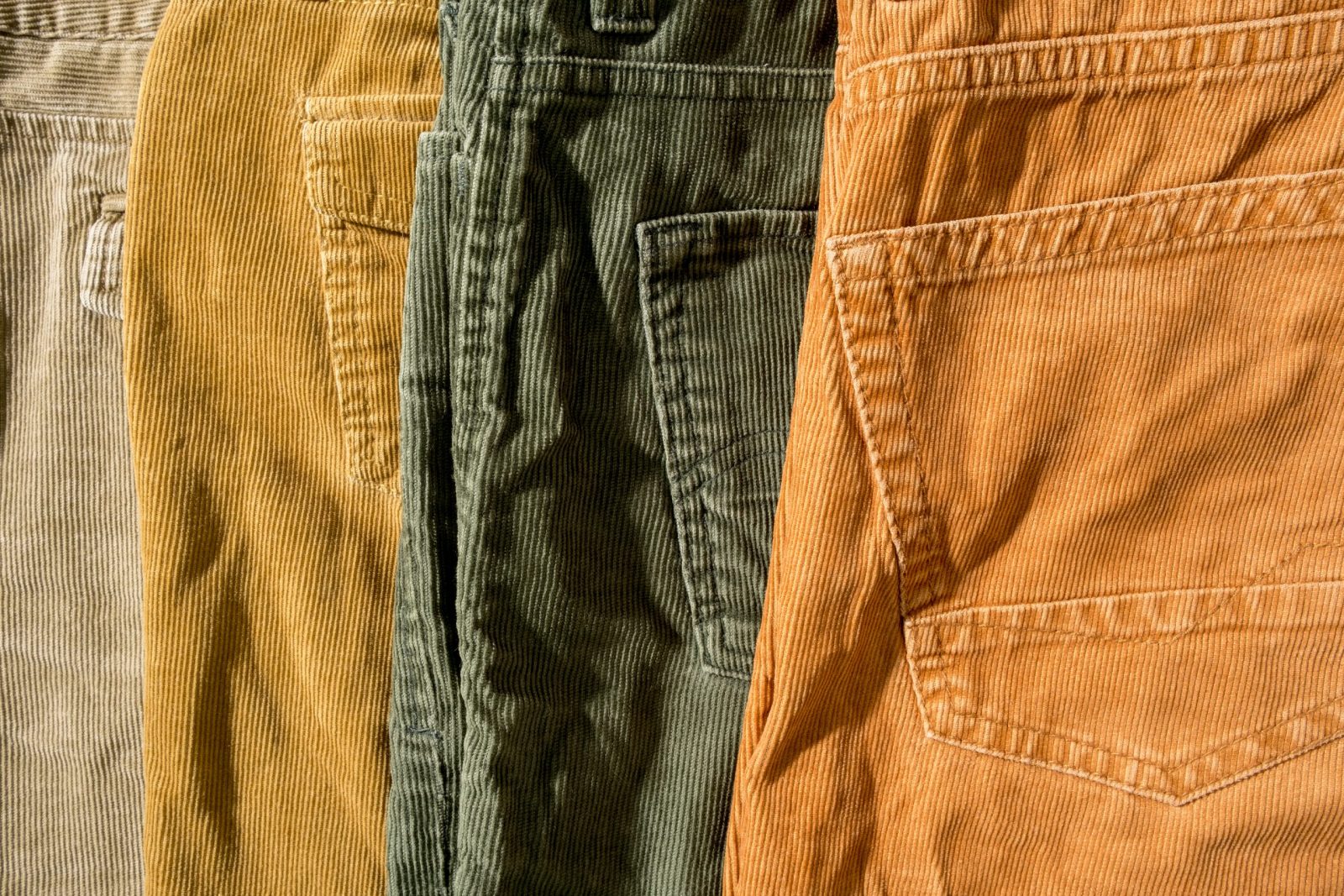 Four different colors of corduroy pants lined up