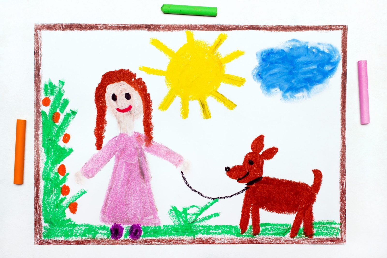 Kid drawing of girl in pink dress with dog