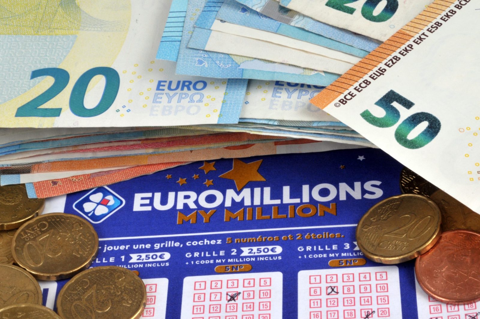 Euromillions grids with money close up