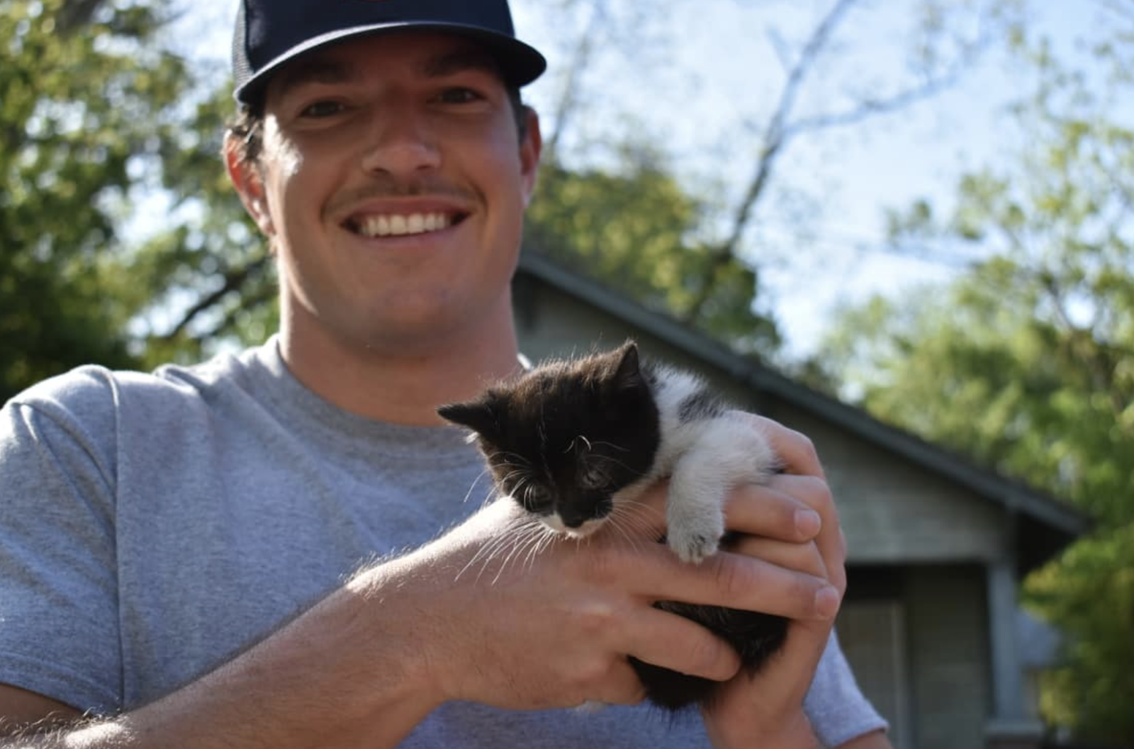 man holding kitten