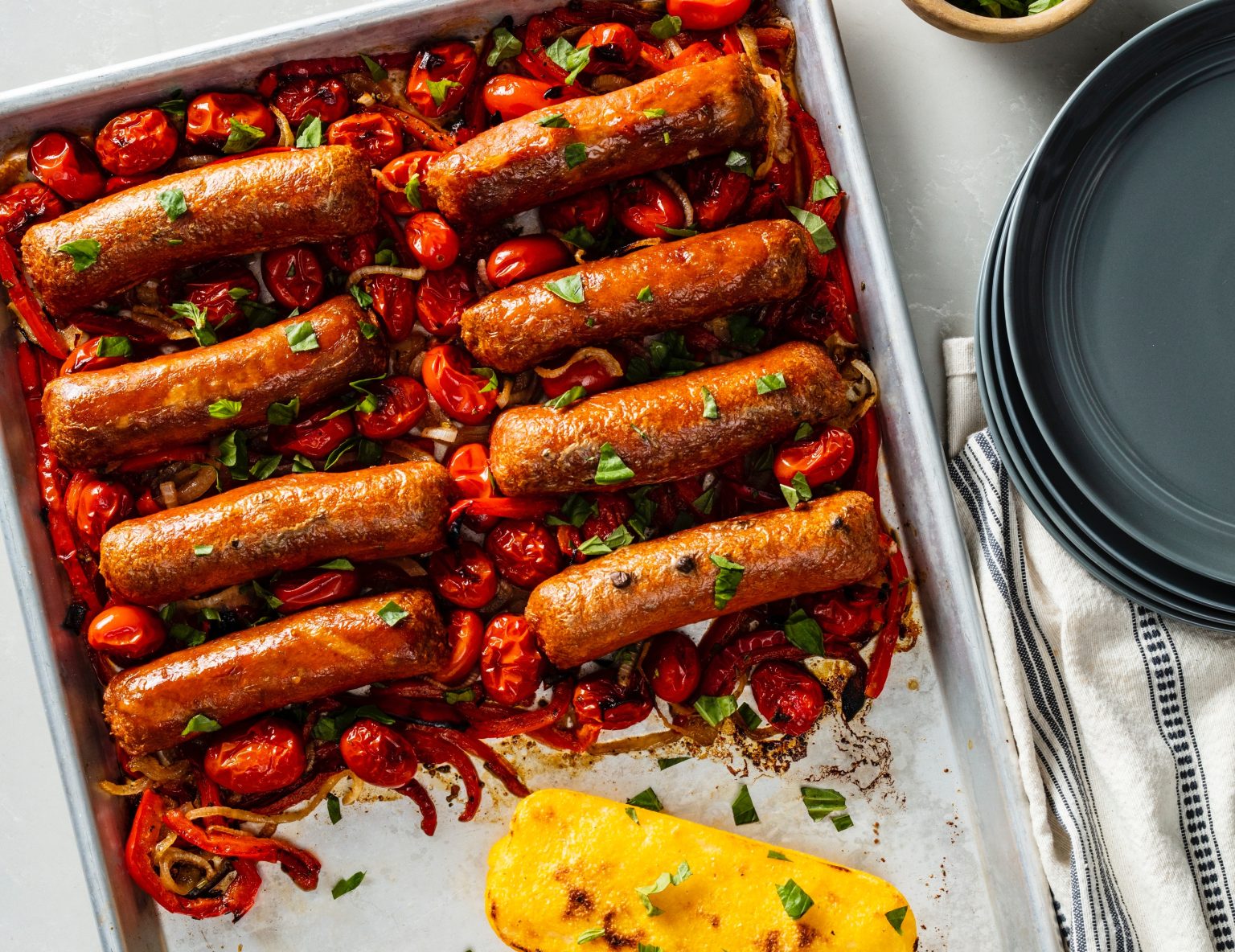 Vegan Sheet-Pan Italian Sausage with Peppers, Onions, Tomatoes, and Polenta