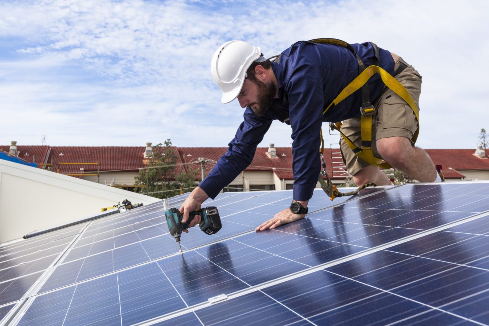 Solar panel technician installing solar panels