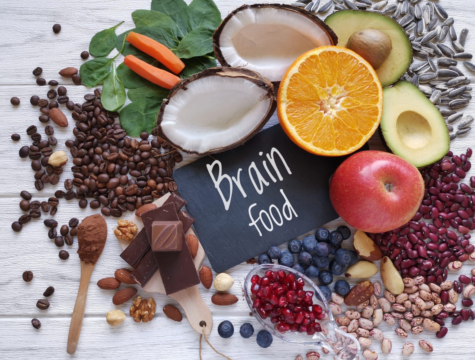 Fruits, nuts, chocolate and beans with a sign reading "Brain food" in the middle