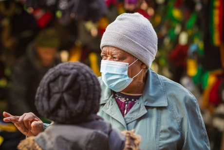 Woman with surgical mask and cap on