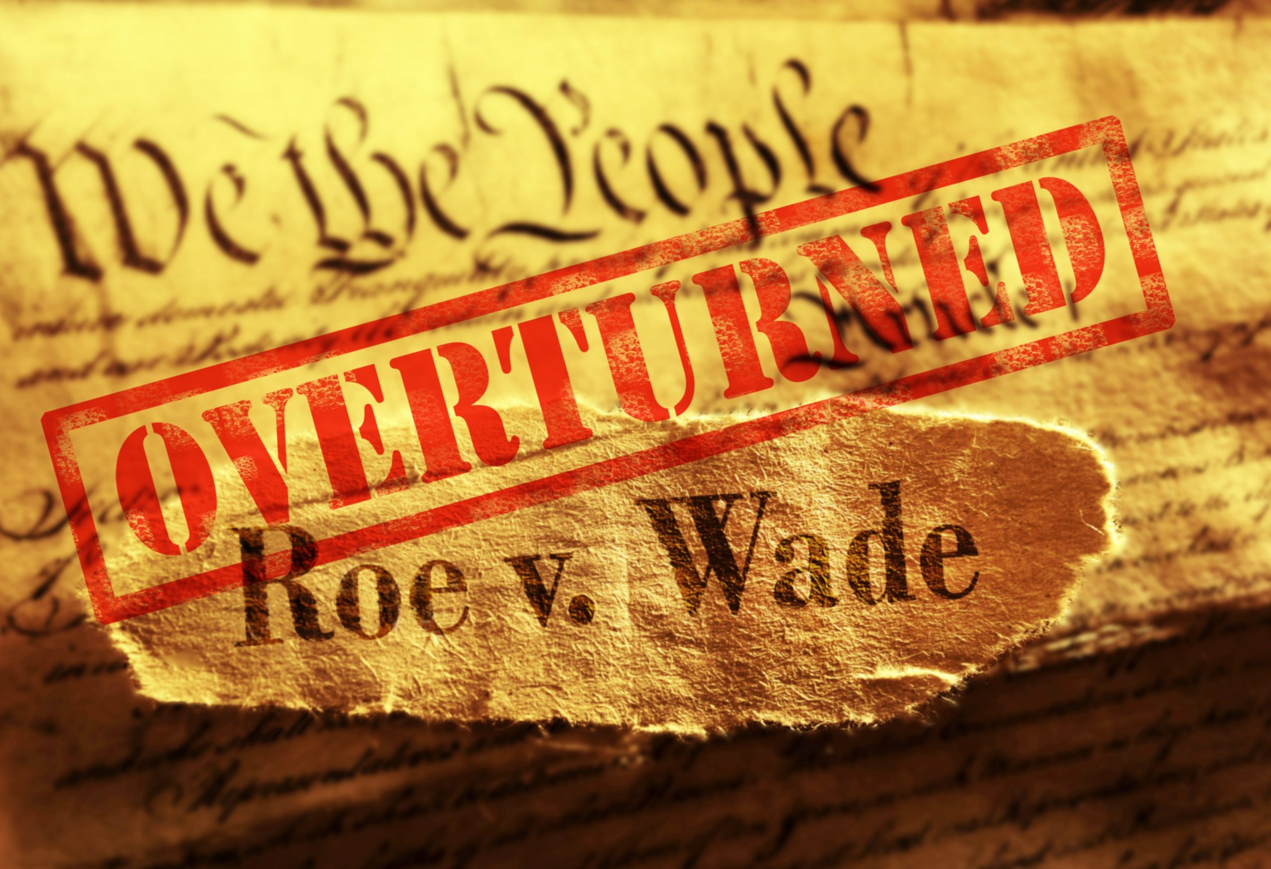 The constitution with the words "Roe v. Wade Overturned" on top of it