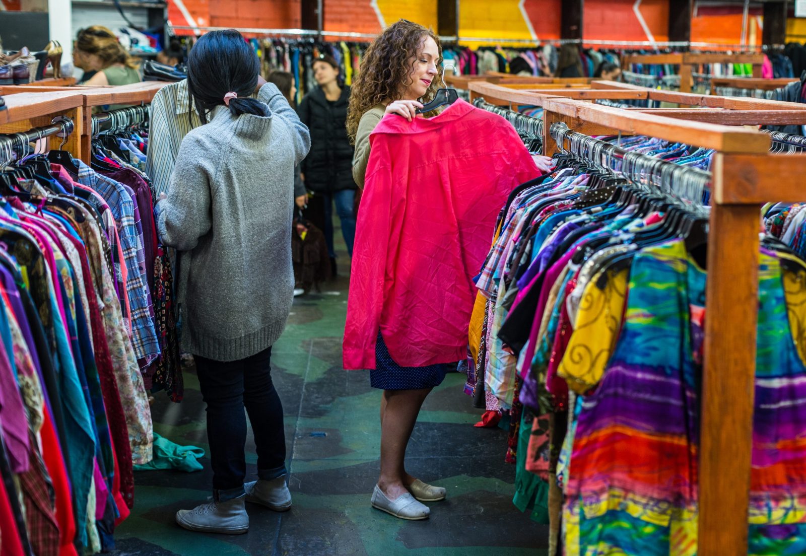 Women looking at clothes in a thrift store