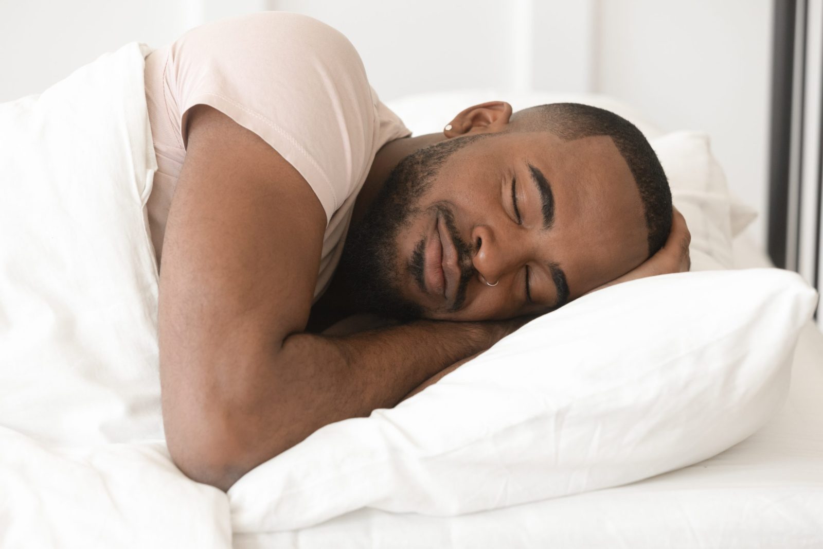 Man sleeping on white pillow
