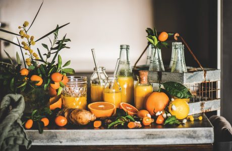 Variety of oranges and juices on a wooden serving tray