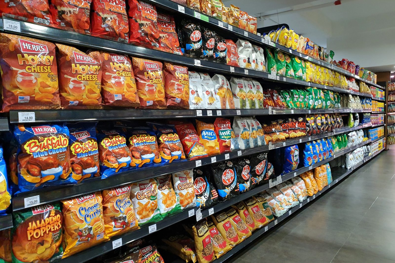 Bags of chips on shelves at grocery store