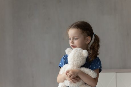 Girl holding teddy bear