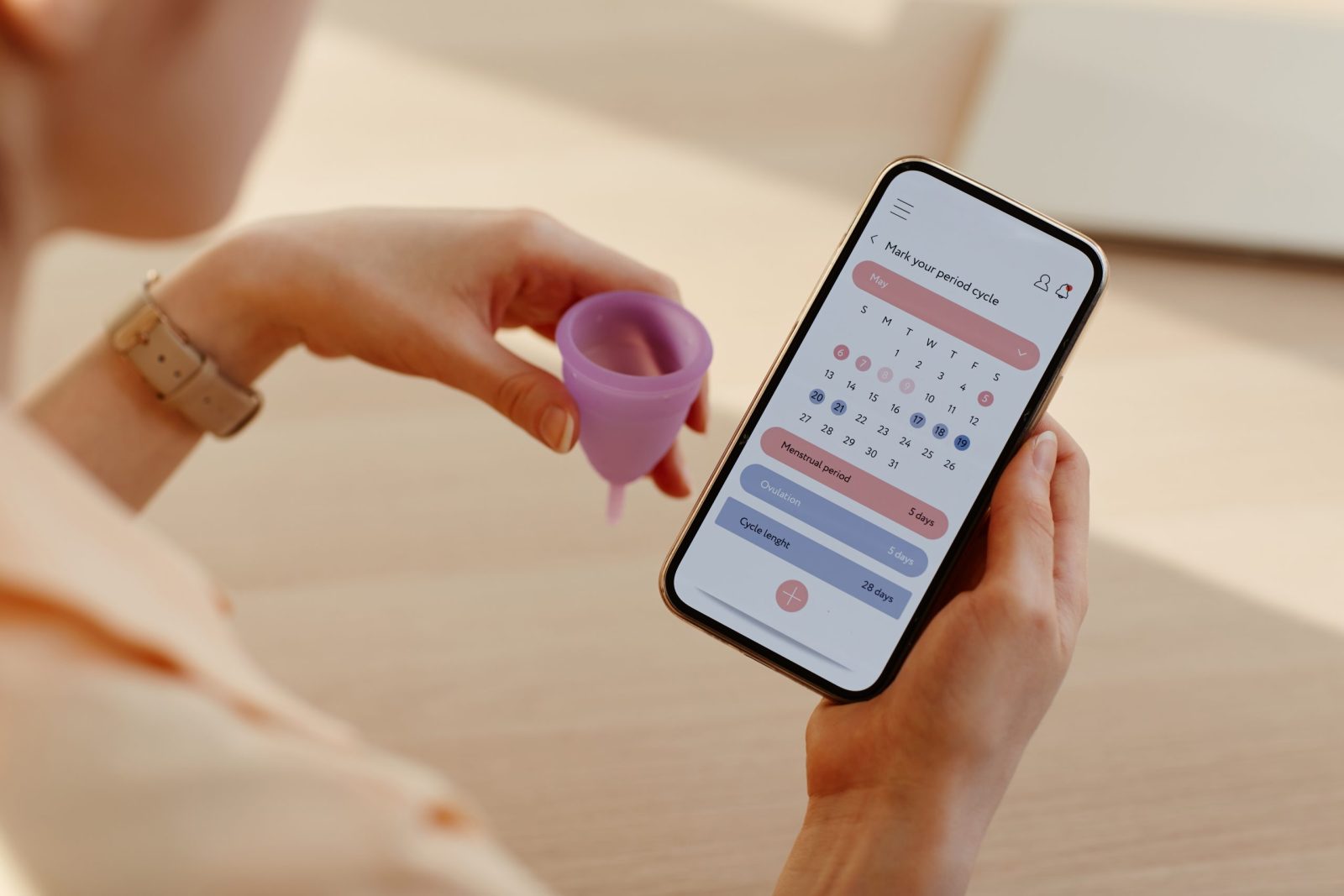 Someone looking at a period tracker app