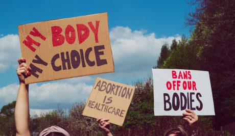 People holding up signs at a pro-choice rally
