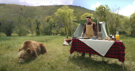 Zac Efron cooking with a live bear outside