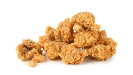 Popcorn chicken in front of white background